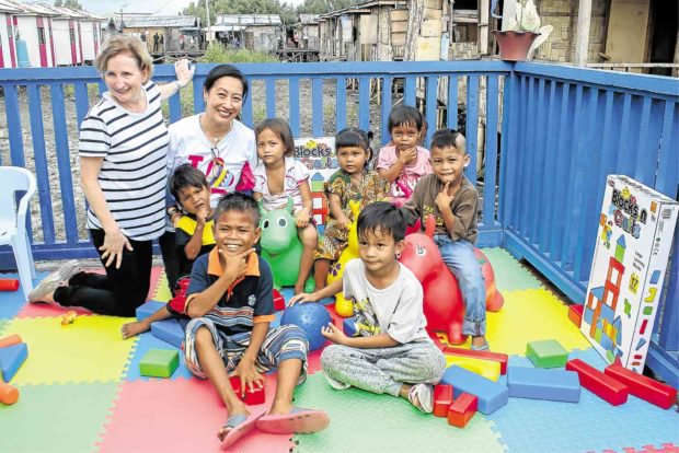 BETTER PROPSECTS Australian Ambassador Amanda Gorely, Mayor Beng Climaco and the children of resettled families at the turnover of Australia's aid grant. CONTRIBUTED PHOTO BY CFSI.