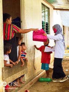 CFSI staff (right) hands dignity kit to a household in Marawi. The dignity kits are provided by the Global Network of Women Peacebuilders (GNWP) from New York, USA. 
